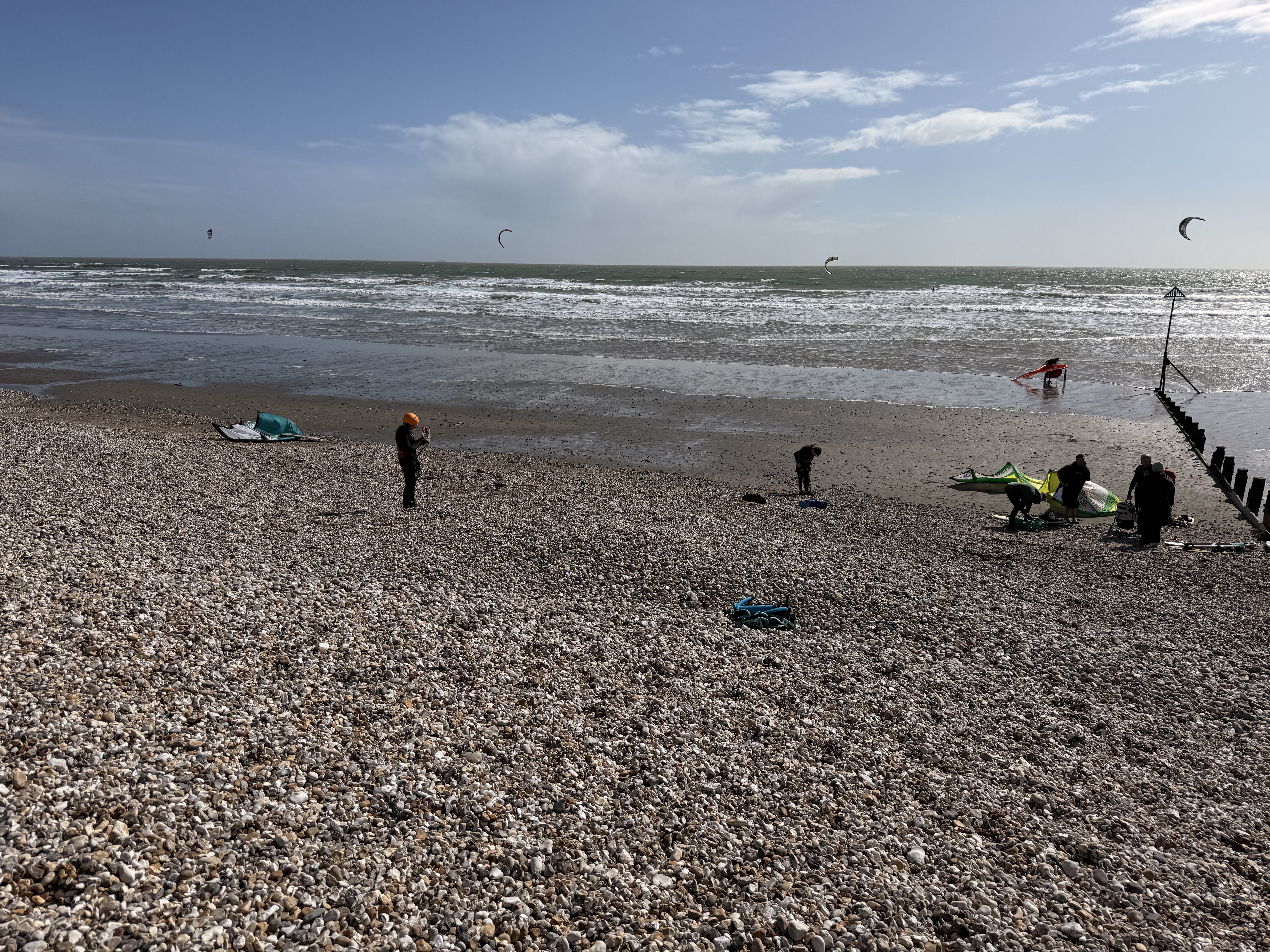 Kite surfers rigging on the shingle beach at East Wittering