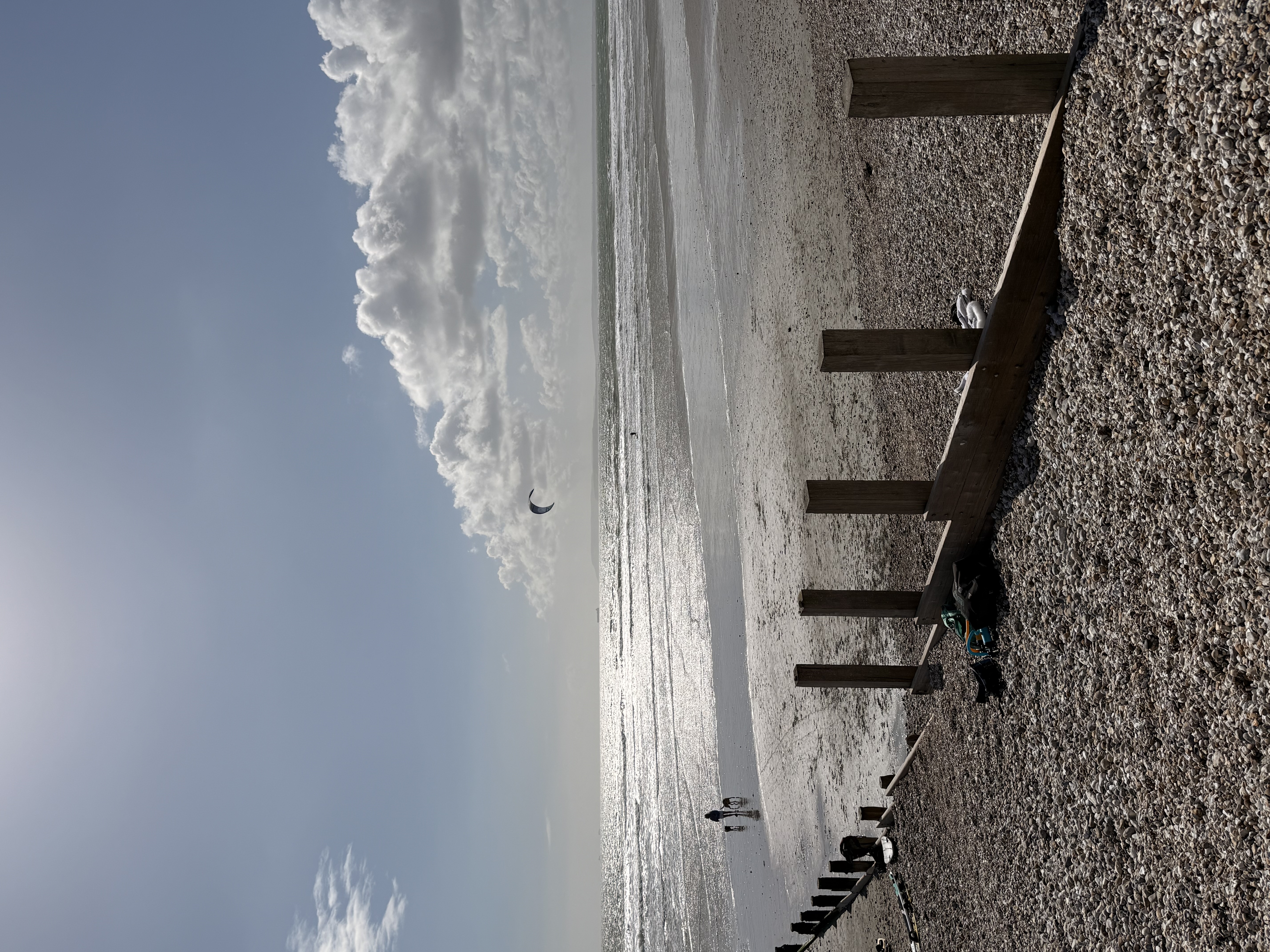 Groyne and lone kite surfer in the distance at low tide