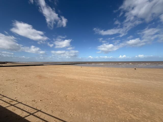 Minnis Bay beach on a sunny March morning — blue sky, high cloud, empty sand